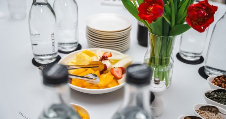 An elegant dining setup featuring fresh fruits and vibrant tulips, perfect for a healthy meal.